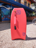 Load image into Gallery viewer, Red bodyboard with leash available for rent at The Frog Pad in Nosara, Costa Rica.